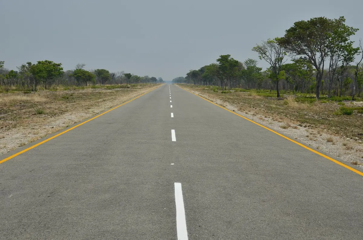 A straight tarred road through woodland in the Caprivi Strip